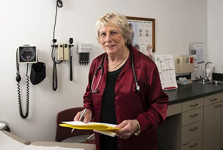 Dr. Donna Sweet stands in an exam room